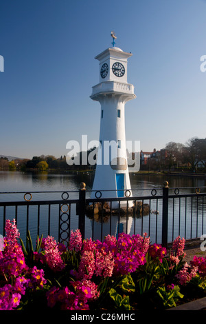 Captain Scott memorial lighthouse at Roath Park Lake with flowers in foreground in spring Cardiff South Wales UK Stock Photo