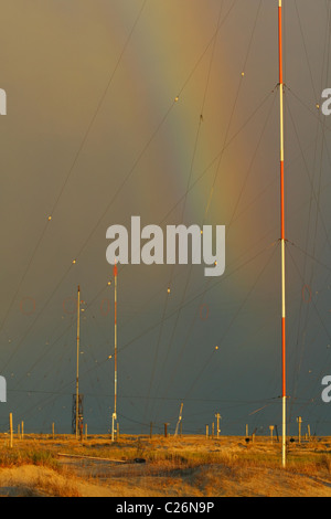 Rainbow over the antenna field on a background of heavy rain clouds. Yamal peninsula, Yamalo-Nenets Autonomous Okrug, RUSSIA Stock Photo