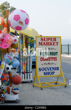Roadside seaside supermarket in Corfu selling beach balls, inflatables, fishing nets, buckets and spades. Stock Photo