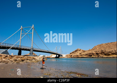 Woman digging for worms in Al Ayjah, Sur, Oman Stock Photo