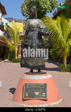 Statue and shopping street in Zihuatanejo, Guerrero, Mexico Stock Photo
