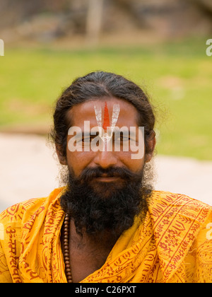 Hindu man sitting at the gates of the Monkey temple (Galwar Bagh) in Jaipur Stock Photo