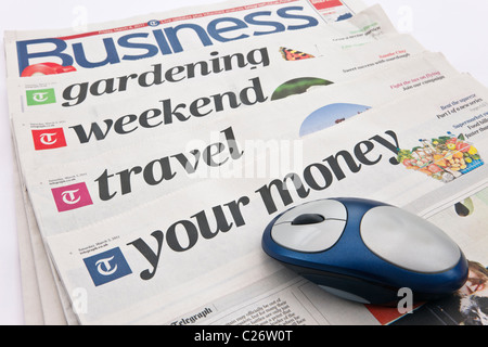 Saturday Telegraph newspaper supplements with a computer mouse to represent the concept of future of the news on the Internet. England UK Stock Photo