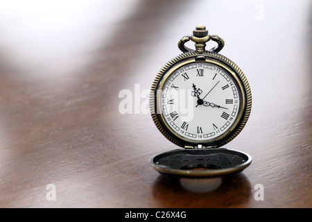 Pocket watch on wooden background Stock Photo