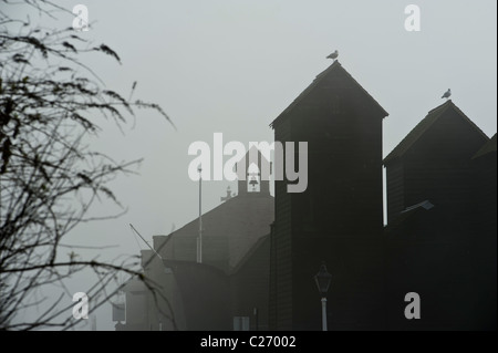 Net huts and Fisherman's Church on a foggy day. Rock-a-Nore. Hastings Sussex UK Stock Photo