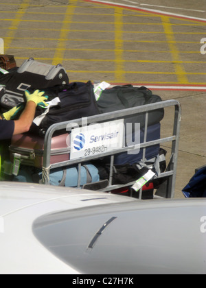 passenger luggage being transported at airport Stock Photo