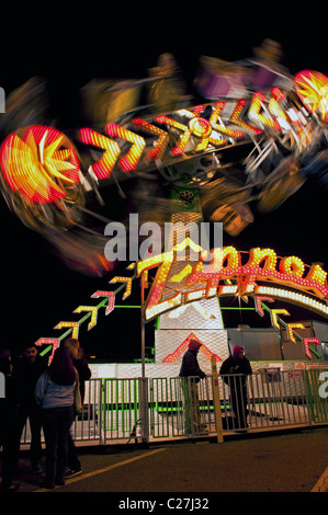 Fast moving ride at a carnival amusement park fair Stock Photo