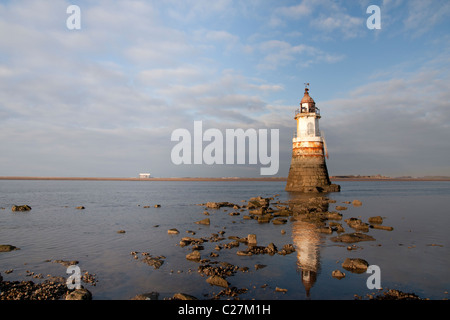 Plover 2 lighthouse in Morecambe bay with Heysham nuclear power station in the distance Stock Photo