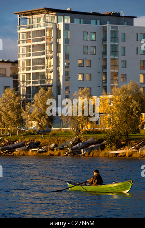 Fisherman trolling from a rowboat / skiff / dinghy at Oulujoki river close to city centre at Oulu , Finland Stock Photo