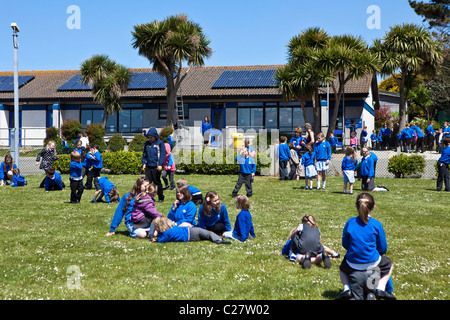 Primary school children playing in the playground of their school at playtime. Stock Photo