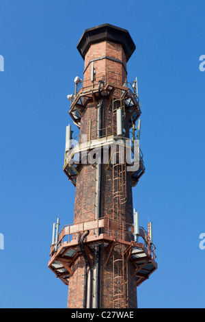 Old mill chimney covered with mobile phone aerials masts or antennae Sandiacre Derbyshire England UK GB EU Europe Stock Photo