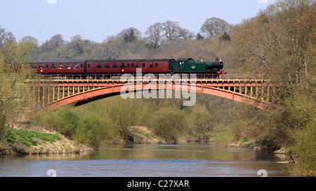 A passenger steam locomotive passing over Victoria Bridge which crosses the River Severn , Worcestershire, England, Europe