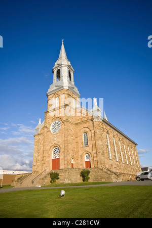 Limsestone brick church, Saint Pierre, in Acadian town of Cheticamp on west coast of Cape Breton Island, Nova Scotia, Canada Stock Photo