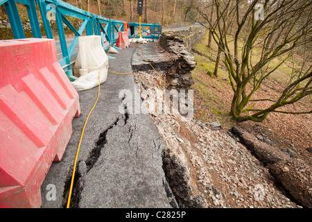 A road in the Langdale Valley collapsed due to extreme weather. Infrastructure damage is becoming more common due to extreme wea Stock Photo