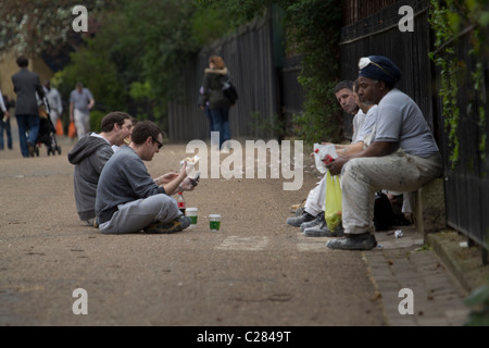Builders construction workers taking lunch break Green Park London Stock Photo