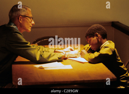 San Francisco, California. Volunteer teaches minority kid writing at Jamestown Community center in San Francisco © Bob Kreisel Stock Photo