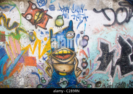 Graffiti wall art in Cancun, Mexico depicting a blue and orange monster. Stock Photo