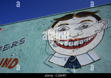 Tillie. Smiling painted face with broken neon on the side of The Palace amusement building, Asbury Park, New Jersey. Stock Photo