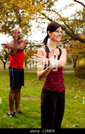 A group of people stretching in the park Stock Photo