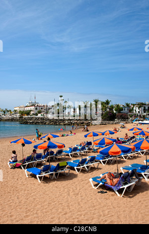 Deck chairs on the beach at Puerto Mogan in Gran Canaria Stock Photo