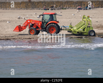 Barber Surf Rake clearing the beach, Looe, Cornwall, UK Stock Photo