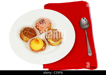 four different muffins on white plate with spoon on red table napkin Stock Photo