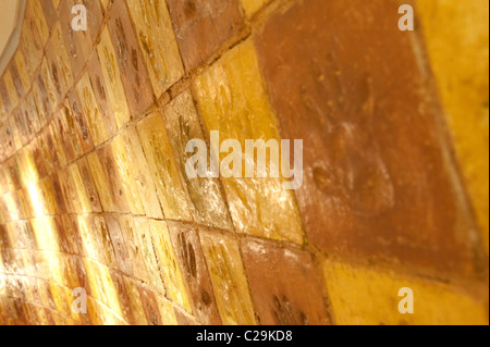 Hand print tiles on a wall in the core at the Eden Project tourist attraction and ecology centre, Bodelva, St Austell, Cornwall Stock Photo