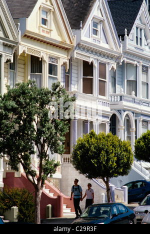 San Francisco, California. Couple walking  past San Franciisco Victorians at Alamo square. © Bob Kreisel Stock Photo