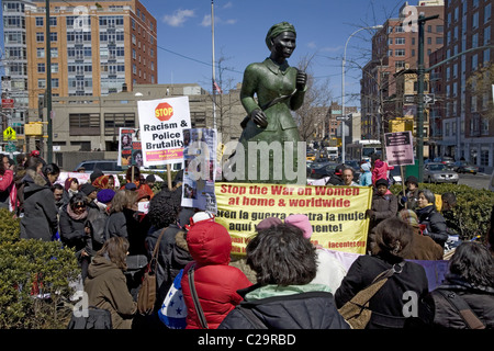 Women rally during International Womens Month at Harriet Tubman Memorial Place in Harlem, New York City. Stock Photo