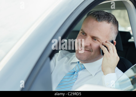 mature caucasian business man calling on the phone and smiling. Horizontal shape, side view, head and shoulders Stock Photo