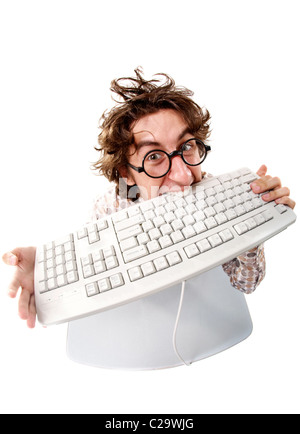 High angle view of a tousled man biting keyboard Stock Photo