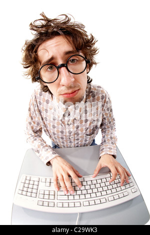 Fish-eye shot of a tousled unhappy man typing on the keyboard Stock Photo