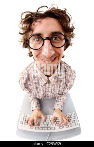 Fish-eye shot of a smiling tousled nerd typing on the keyboard Stock Photo