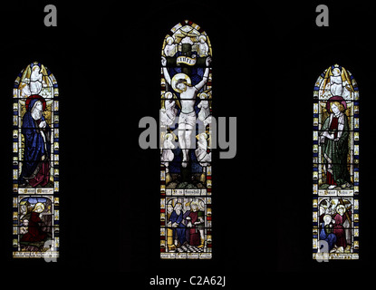 A stained glass window by Burlison and Grylls depicting the Crucifixion, All Saints Church, Watermillock, Cumbria Stock Photo