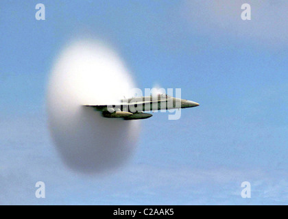 Caught on camera - a US Navy jet breaks the sound barrier and creates a white vapour cone / cloud known as a 'shock collar'. Stock Photo