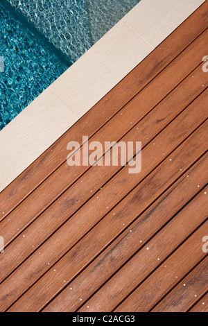 New timber decking by the side of a swimming pool Stock Photo