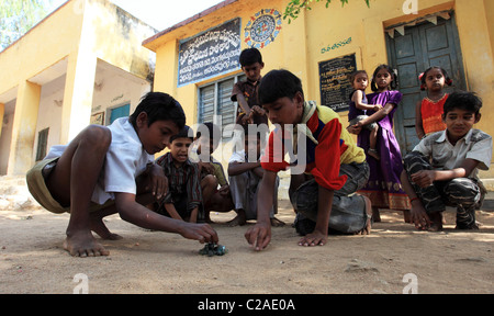 Indian boys playing with marbles Andhra Pradesh South India Stock Photo