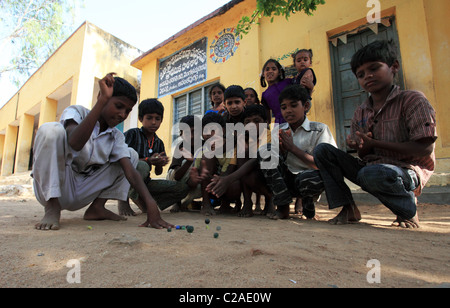 Indian boys playing with marbles Andhra Pradesh South India Stock Photo