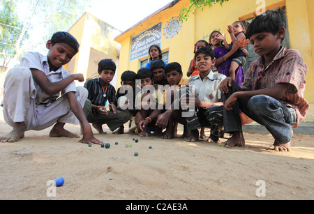 Indian boys playing with marbles Andhra Pradesh South India Stock Photo