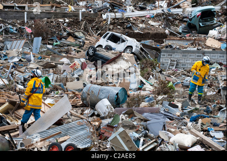 Japanese search and rescue teams search for survivors after thousands of homes were destroyed in Ofunato, Japan 2011. Stock Photo