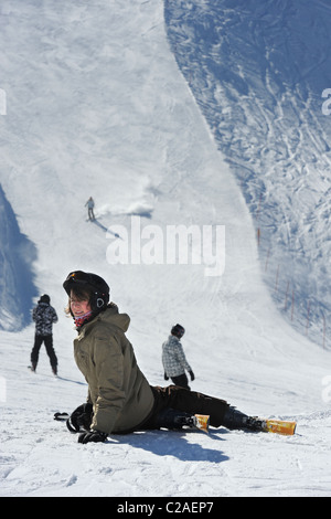 A boy rests after a skiing fall at the Vogel Ski Centre on the the Sija - Zadnji Vogel piste in the Triglav National Park of Slo Stock Photo