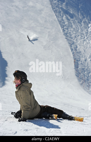 A boy rests after a skiing fall at the Vogel Ski Centre on the the Sija - Zadnji Vogel piste in the Triglav National Park of Slo Stock Photo