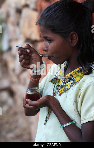 Indian girl eating honey Andhra Pradesh South India Stock Photo - Alamy