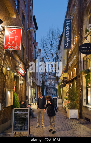 Young couple looking at a menu outside a restaurant on Wijngaardstraat in the old city, Antwerp, Belgium Stock Photo