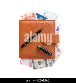 Business daily organizer filled with various money and credit card and open fountain ink pen on top of it. Stock Photo