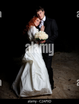 Bride and groom at their wedding day. River bank at night. Up state New York. Model release signed. Stock Photo