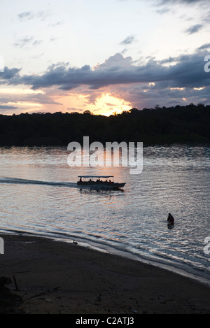 South America, Amazon, sun setting behind rainforest Stock Photo