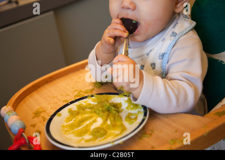 Baby girl chewing on spoon Stock Photo