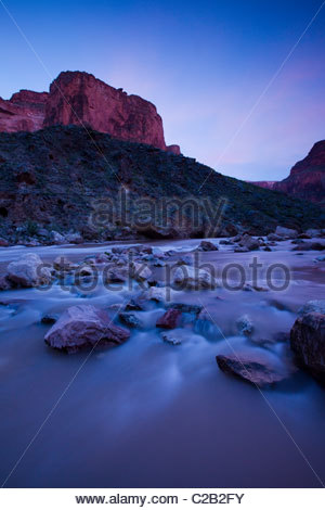 Colorado river rushing over stones at twilight Stock Photo - Alamy