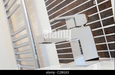 Close up of a mixer tap on a sink in a modern bathroom. Stock Photo
